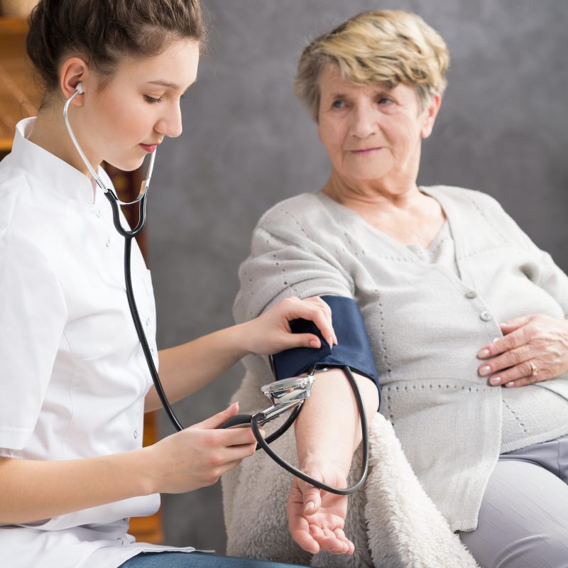 nurse-taking-elderly-woman-s-blood-pressure